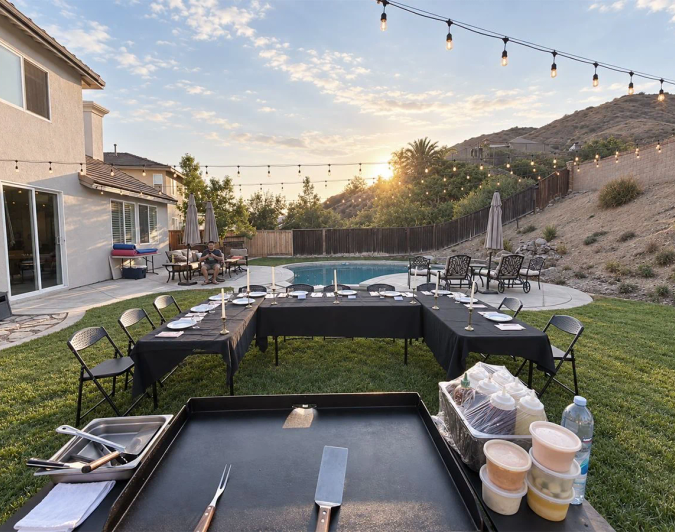 View from behind the grill toward a U-shaped guest table set for a private hibachi dinner