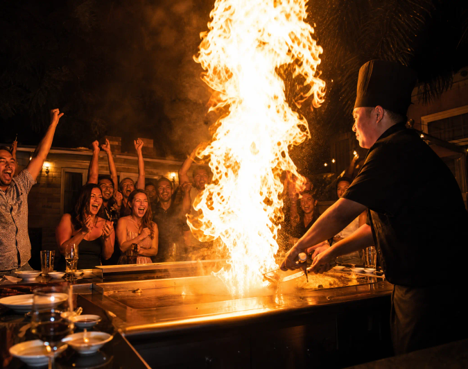 Hibachi chef performing a fire show at an Orange County backyard party