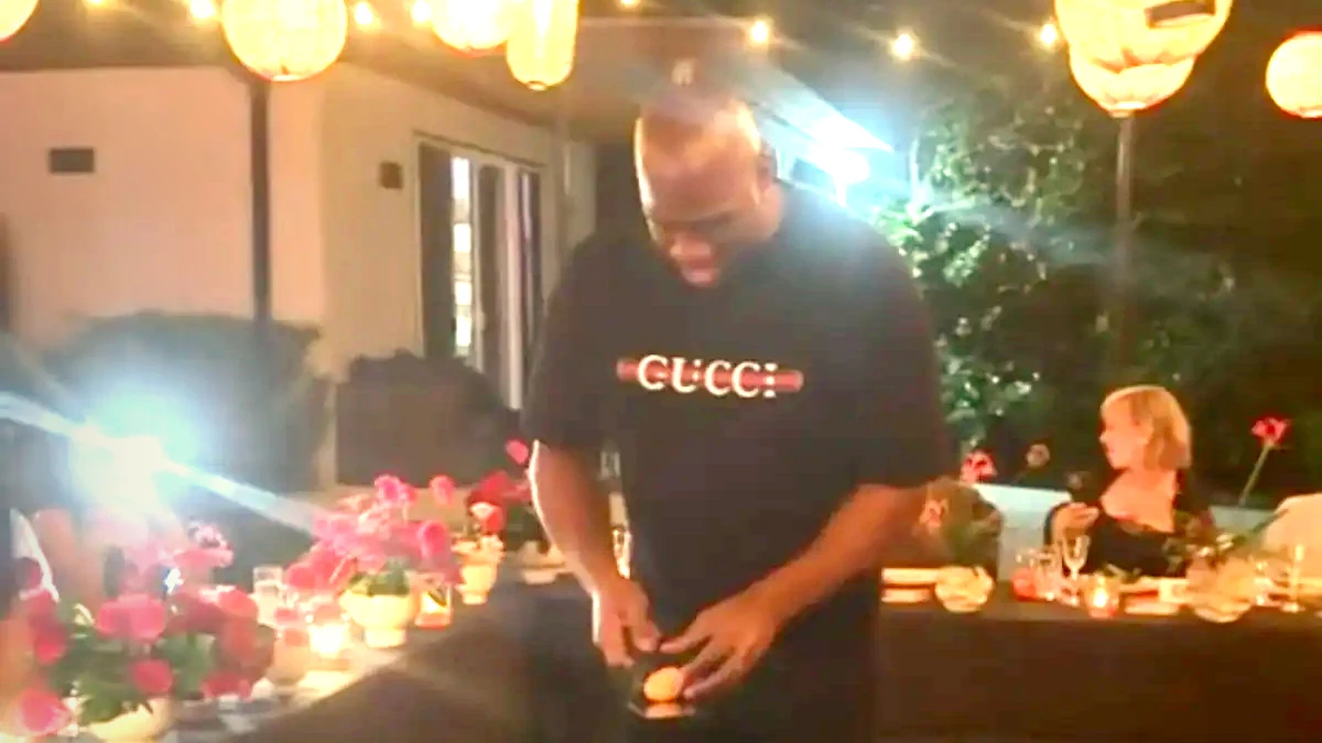 Johnson holding a spatula during a private hibachi event.